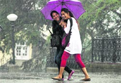 Girls enjoy a walk in the rain at Shimla on Tuesday. Photo: Amit Kanwar
