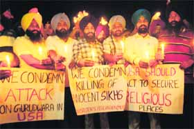 Activists of the Sikh Students Federation (Mehta) take out a candlelight march for those killed in US gurdwara firing, in Amritsar on Tuesday. 