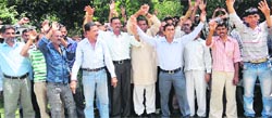 Daily-wagers of the Public Health Engineering (PHE) department stage protest at Reasi on Tuesday. A Tribune Photograph
