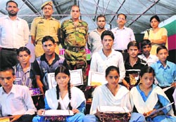 Commanding Officer, Rashtriya Rifles battalion, distributes prizes among the winners and participants of the competition at Talwara on Tuesday. A Tribune Photograph