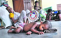 A child sleeps on the floor at a relief camp in Kokrajhar on Tuesday