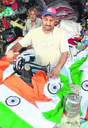 A tailor in Patiala stitches National Flags ahead of Independence Day.