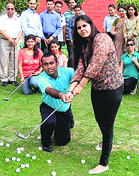 A golfer gives tips to youngsters during the launch of a golf acdemy at GJIMT, Mohali, on Wednesday.