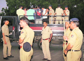 The police takes outsiders for verification during raids at PU hostels on Wednesday. 