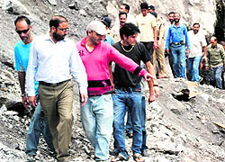 Urban Development and Housing Minister Pritam Singh Panwar assesses the damage caused due to a landslide in the Kempty area near Mussoorie on Wednesday