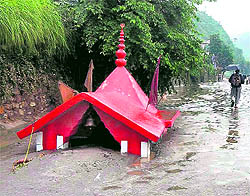 A riverside shrine buried in silt carried in the Bhagirathi, which experienced flash floods, in Uttarkashi on Wednesday
