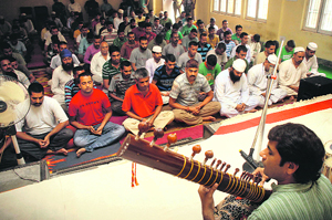 Renowned meditation music therapist Raj Kumar holds a workshop for inmates of the district jail, Ambphalla in Jammu on Wednesday. 