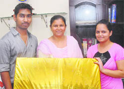 Rita Rani of Nawanshahr with the LCD she won in the lucky draw of a scheme of the Department of Posts and Western Union Money Transfer in Jalandhar on Wednesday. 