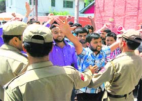 Activists of the National Volunteer Corps raise slogans in support of their demands in Srinagar on Wednesday