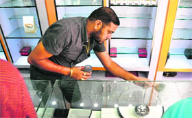 A fingerprint expert examines the site where the theft took place at Ghumar Mandi in Ludhiana on Wednesday.