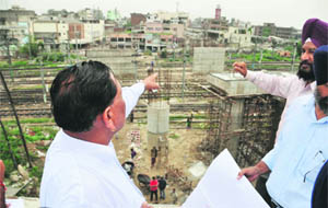 MLA Prem Mittal (left), chairman of the local bodies committee, Punjab Vidhan Sabha, inspects the Lakkar Bridge project in Ludhiana on Wednesday. 