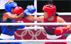Mary Kom (R) punches Great Britains Nicola Adams during their semifinal bout at the ExCel Arena in London on Wednesday. Mary put up a brave fight but had to settle for a bronze, Indias fourth medal at the Games.  PTI