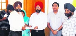 Civil Surgeon Dr Hardeep Singh Ghai along with District TB Officer Dr Naresh Chawla honours private DOTS providers in Amritsar on Thursday. A Tribune photo 