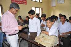 Bathinda MLA Sarup Chand Singla interacts with a student of Government Senior Secondary School at Paras Ram Nagar in Bathinda on Thursday.