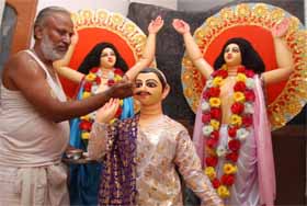 An artist gives finishing touches to his creation ahead of Janmashtami in Bathinda on Thursday. 