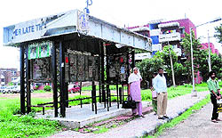 Broken seats, torn off advertisement panels and posters of a student organisation welcome commuters at a bus queue shelter in Sector 43