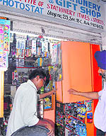 Police officers in civil dress inspect a shop at Sector 18 in Chandigarh on Thursday