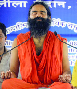 Baba Ramdev performs yoga on the first day of his three-day fast at the Ramlila Grounds in New Delhi