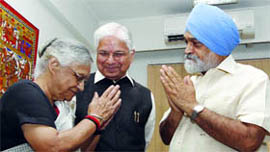 Chief Minister Sheila Dikshit greets Deputy Chairman of the Planning Commission Montek Singh Ahluwalia as Minister of State for Planning Ashwani Kumar looks on in New Delhi on Thursday.