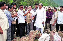 Chief Minister Vijay Bahuguna monitors distribution of relief material among people during a visit to disaster-hit areas in Uttarkashi