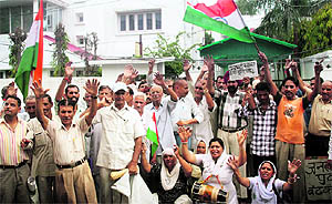 Members of the PoK Refugee Front stage a protest outside Congress MP Lal Singhs house in Jammu on Thursday