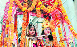 Children, dressed as Lord Krishna and Radha, take part in a procession in Jammu on Thursday
