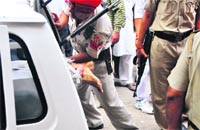 The police takes away the body of the victim from Field Gunj in Ludhiana on Thursday. tribune photo: Himanshu Mahajan