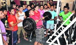 A participant in action at a biceps competition that was held at a health club in Ludhiana. A Tribune photograph