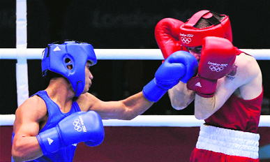 Devendro Singh (L) punches Paddy Barnes in London on Wednesday.