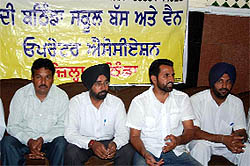 Members of the Bathinda School Bus and Van Operators Association air the problems being faced by them, at a press meet in Bathinda on Friday