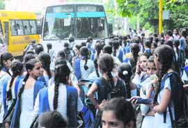 Students rush at a bus stop in Sector 18, Chandigarh.