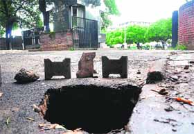 Rain exposed the poor quality of material used in the repair of roads in the city when a portion of the road in front of Government Medical College and Hospital (GMCH), Sector 32, caved in on Friday. The caved-in portion is about 2.5 feet in width and 5 feet in depth. The staff of the department concerned have just put up two or three bricks around the damaged portion so as to prevent an accident.