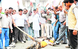 Activists of the Indian National Trade Union Congress stage a protest at Ranipur Mod in Haridwar on Friday.