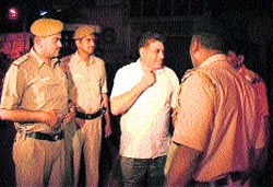 The Delhi Police outside Gopal Kandas residence at Sirsa on Thursday night. A Tribune photograph 