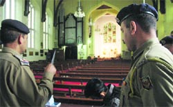 Policemen investigate at the Christ Chu