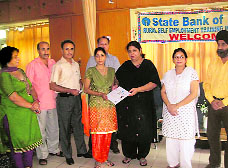 Kalpana Revo, Chief Judicial Magistrate, Reasi, distributes certificate to a successful candidate.