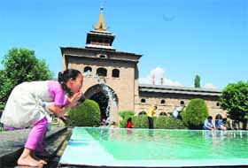 A girl splashes her face with water ahead of afternoon prayers at Jamia Masjid in Srinagar. A huge rush is being witnessed at the mosque these days on account of Ramadan. 