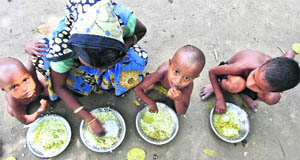 A family has lunch at a relief camp near Bilasipara town in Assam. 