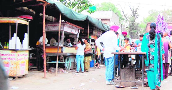 Residents relish street food at stalls in Amritsar. A Tribune photo