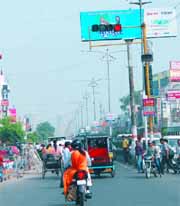 Commuters make their way past a red light at a traffic signal on a busy stretch in the city. Awareness about traffic rules remains a far cry in Bathinda. 
