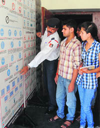 Traffic police officials interact with students at the PGGC-11 in Chandigarh on Saturday. 