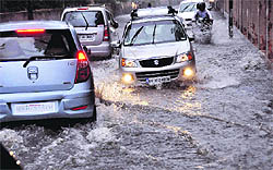 A road turns into a rivulet following heavy rain in Dehradun on Saturday evening. 