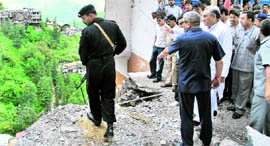 Chief Minister Vijay Bahuguna assesses the damage caused due to heavy rains and landslides in the Kempty Falls area in Mussoorie on Saturday;