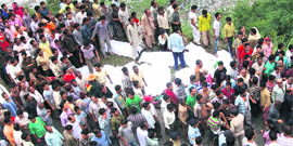 Villagers gather at the bus accident site in Chamba on Saturday.