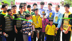 Prof Talat Ahmad, Vice-Chancellor, Kashmir University, with a group of children at the release of JKYFs annual report 2011-12 in Srinagar on Saturday. 