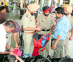 Ahead of the Independence Day celebrations, for precautinary measures, policemen frisk the luggage of passengers at the bus stand in Jalandhar on Saturday