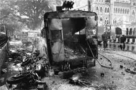 Torched vehicles near CST Station in Mumbai on Saturday.