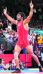 Yogeshwar Dutt celebrates his bronze medal win over North Koreas Jong Myong RI on Saturday