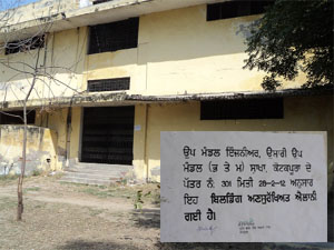 (Above) Poor condition of the lintel and plaster of the building of the Shaheed Bhagat Singh Degree College in Kotkapura raises questions over the safety of students, teachers and staff; (inset) a notice of the PWD (B&R) pasted on a wall of the college declares the building unsafe.