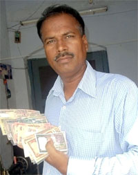 Raj Singh Dahiya carries Indian currency with 786 as last three digits.